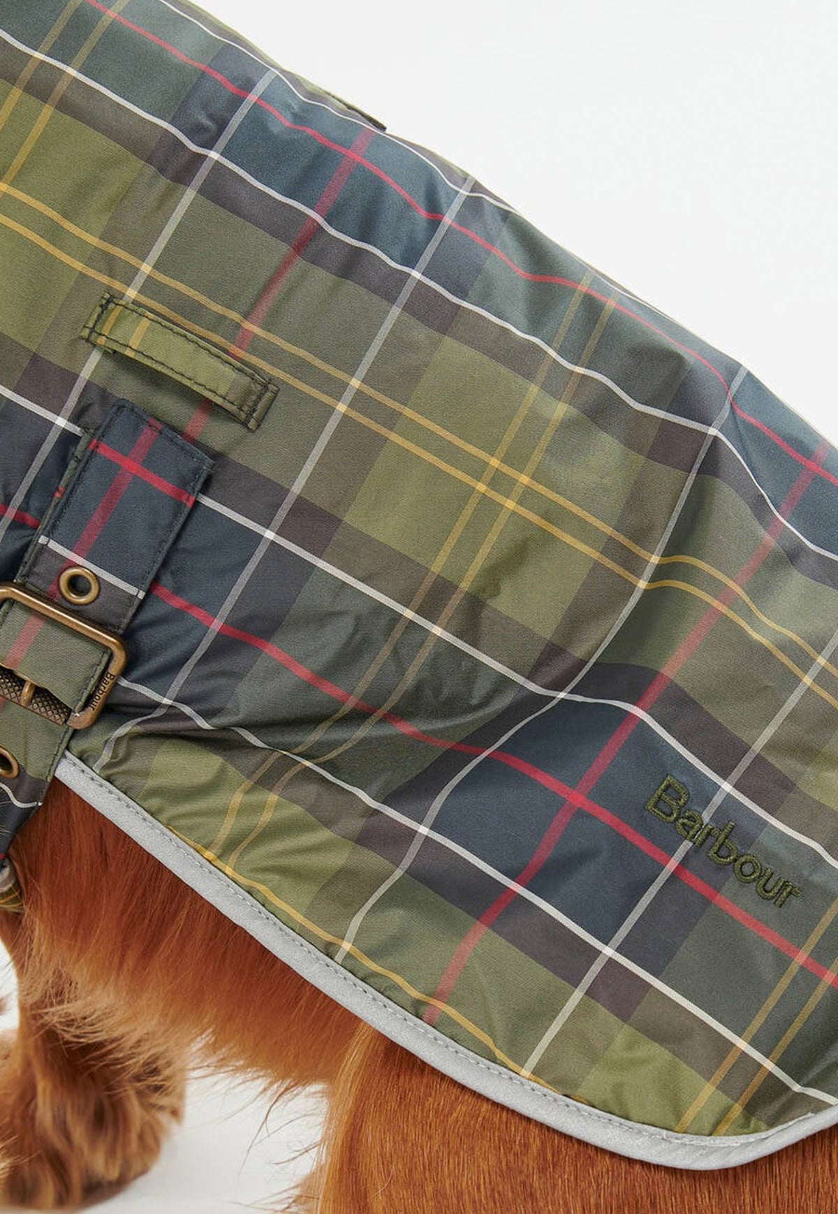 Close-up of the Barbour Waterproof Tartan Dog Coat featuring a soft fleece lining, cord collar and reflective trim.