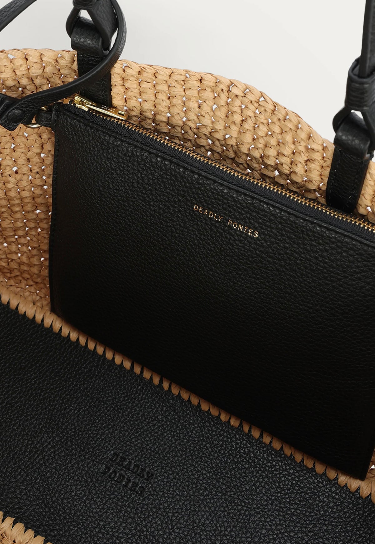 Featuring the detachable zipped pouch for smaller essentials.