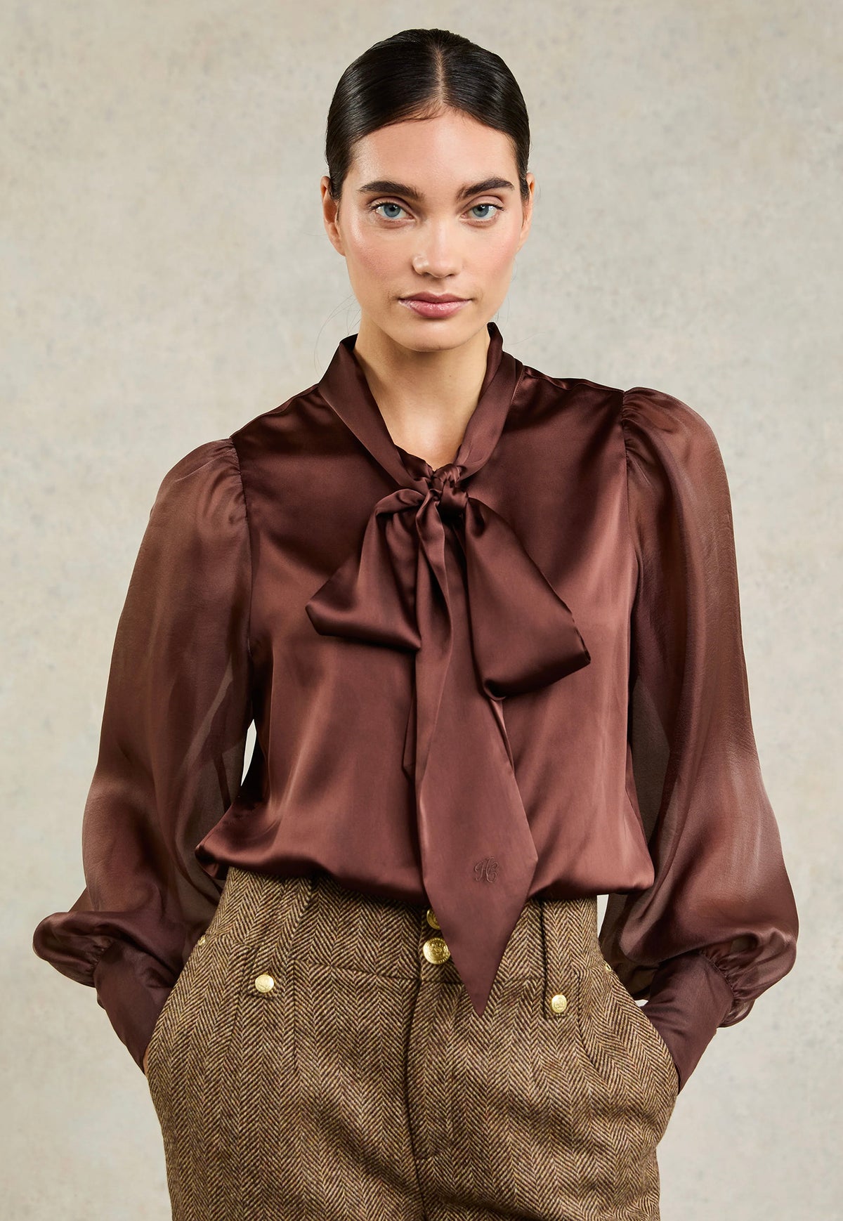 Holland Cooper Ariella Blouse in Chocolate satin, featuring an oversized bow collar, relaxed silhouette, long floaty sleeves and extended cuffs.