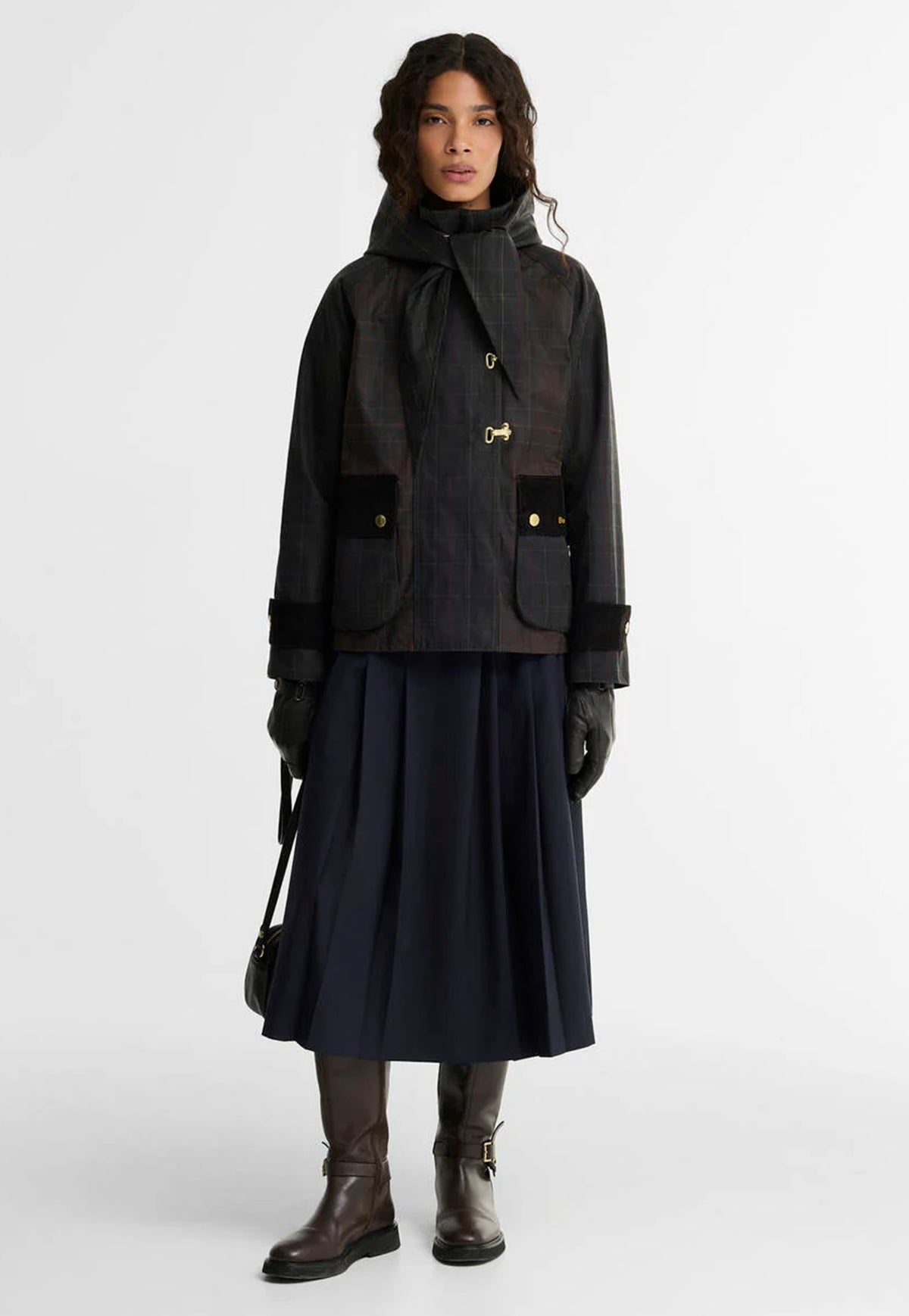 Barbour Arlene Waxed Headscarf styled beneath the chin over a waxed jacket for a classic country-inspired look.