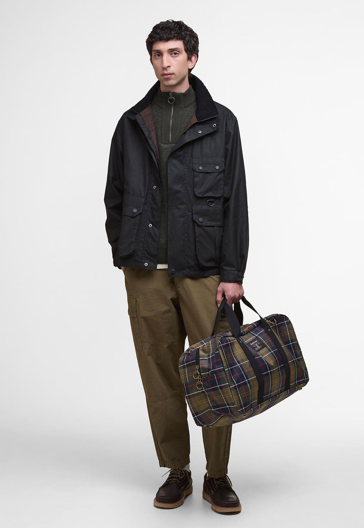 Barbour Torridon Tartan Holdall carried as a weekend travel bag, showing its spacious design and classic tartan finish.