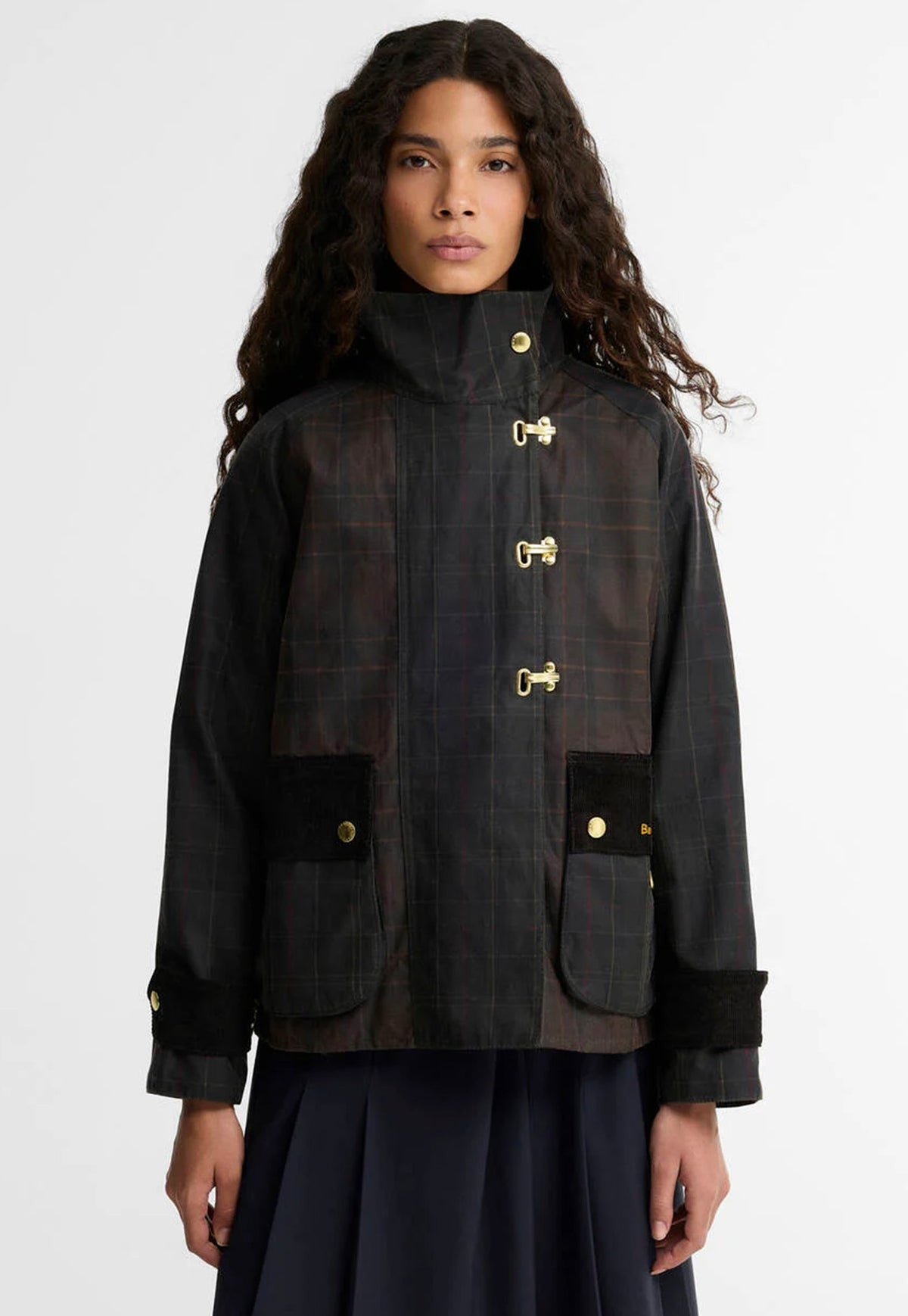 Barbour Hazelwood Checked Waxed Jacket featuring patchwork check waxed cotton, funnel collar, bellows pockets and brass fisherman clips.