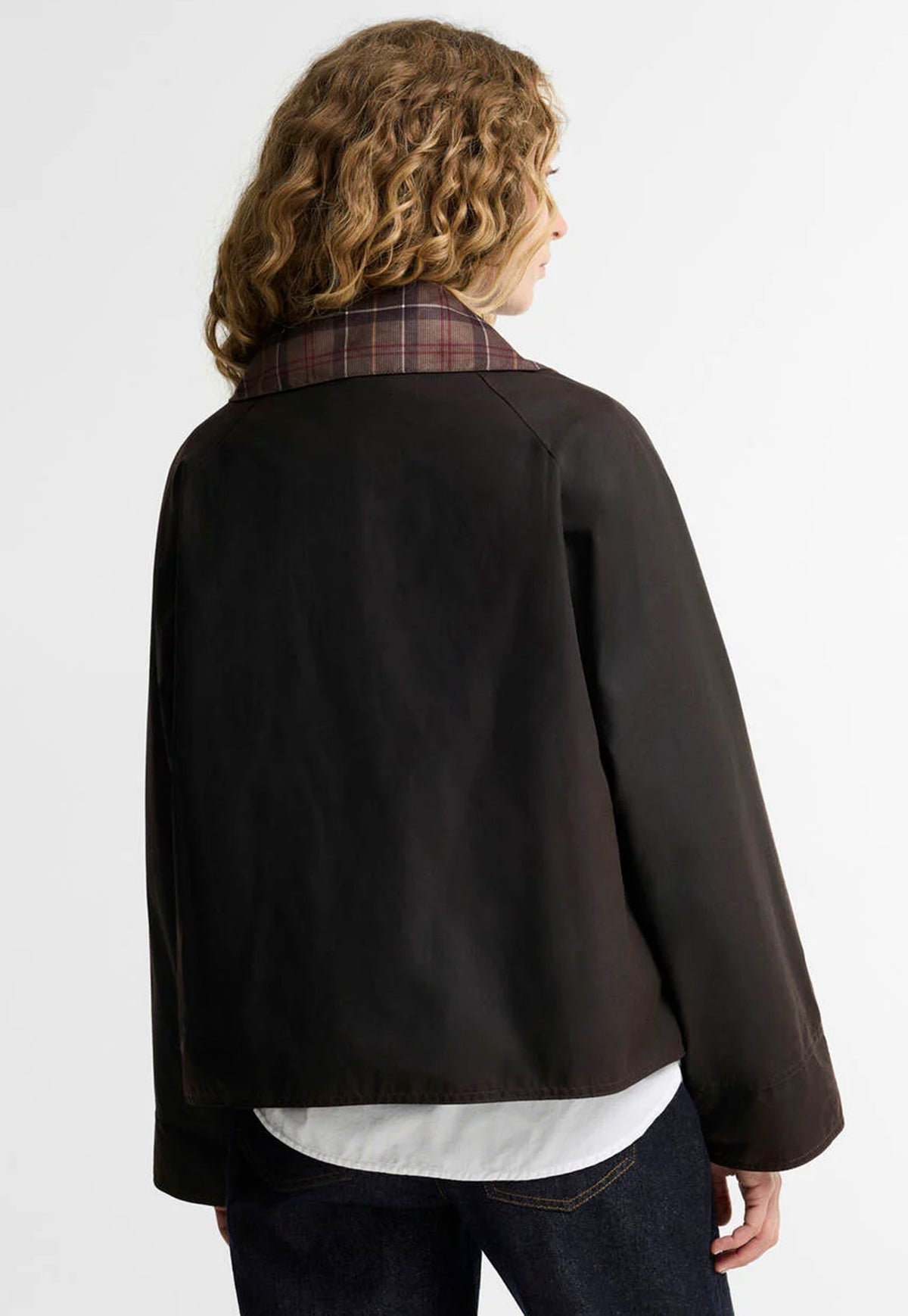Back of the Barbour Icons Tartan Collar Spey Waxed Jacket showing its short silhouette and waxed cotton finish.