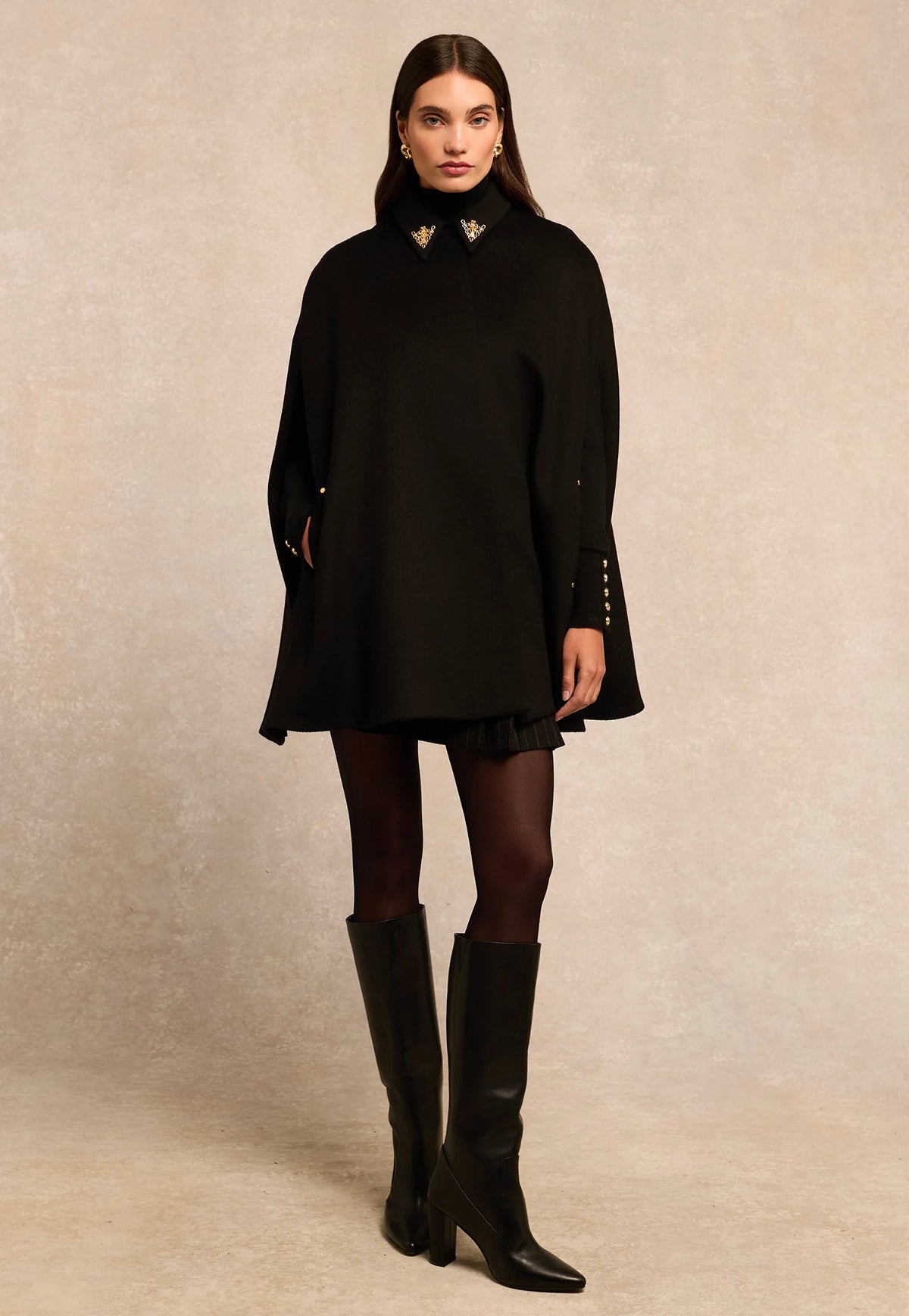 Holland Cooper Knightsbridge Cape in Soft Black, featuring a tailored shoulder fit, gold HC collar hardware and signature embroidered back detailing.