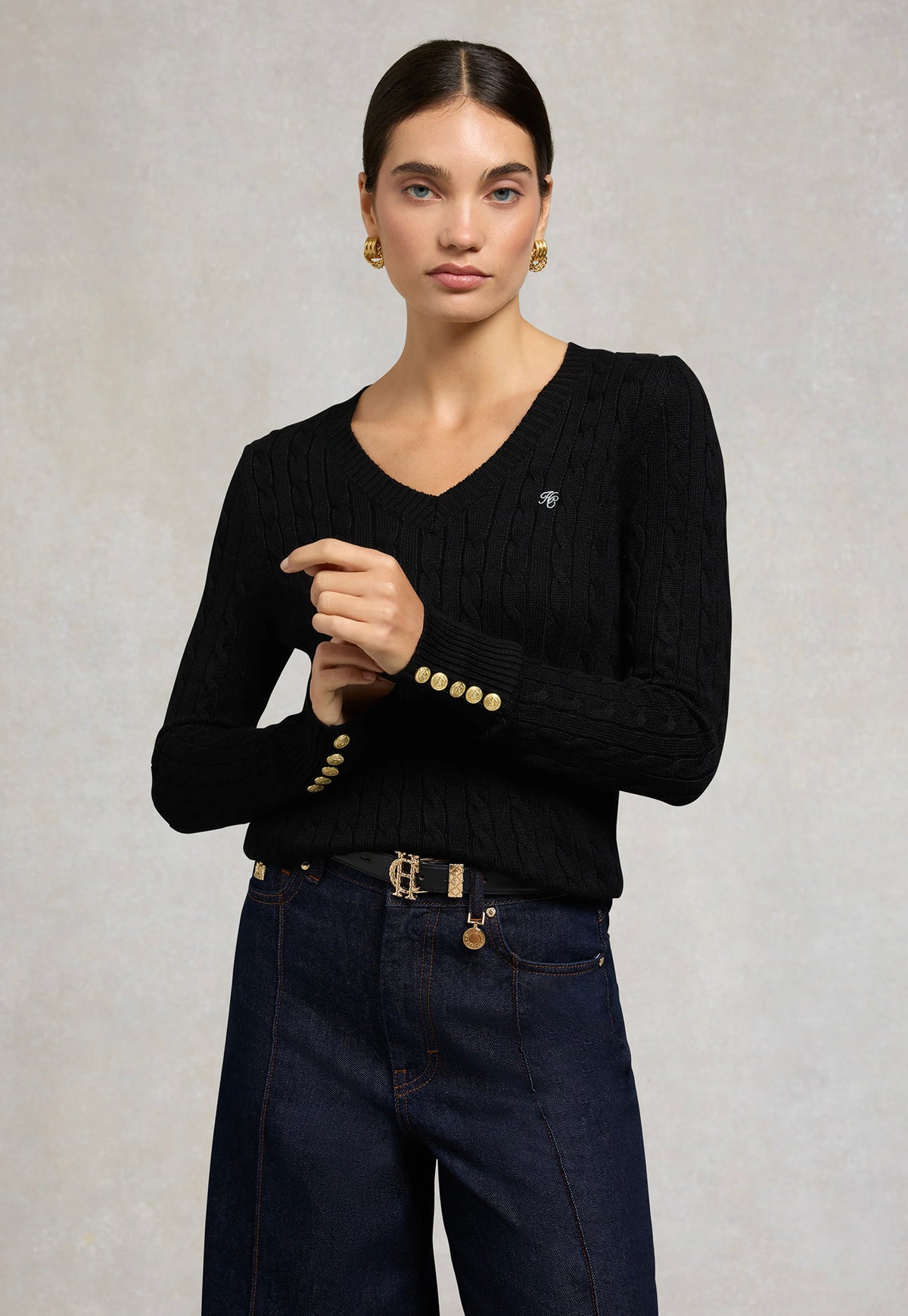 Holland Cooper Seattle V-Neck Knit in Black, featuring a cable-knit design, V-neckline, long sleeves and signature gold HC hardware at the shoulders and cuffs.